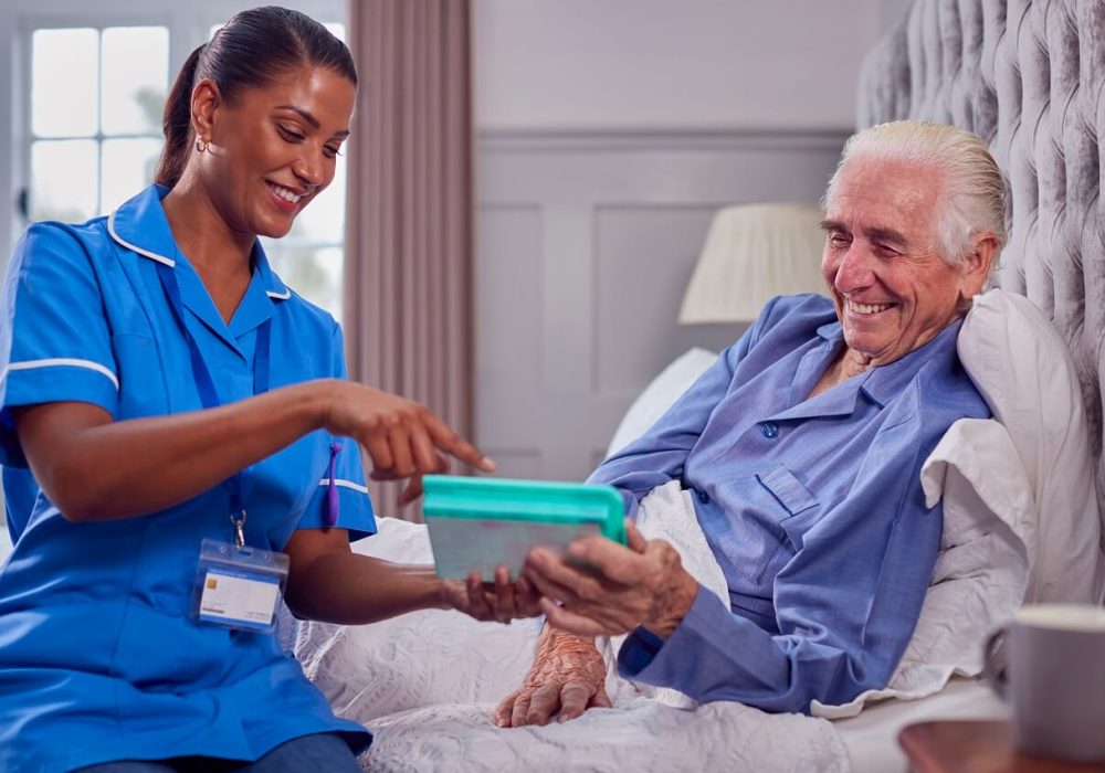 female-care-worker-uniform-helping-senior-man-home-bed-with-medication female-care-worker-uniform-helping-senior-man-home-bed-with-medication